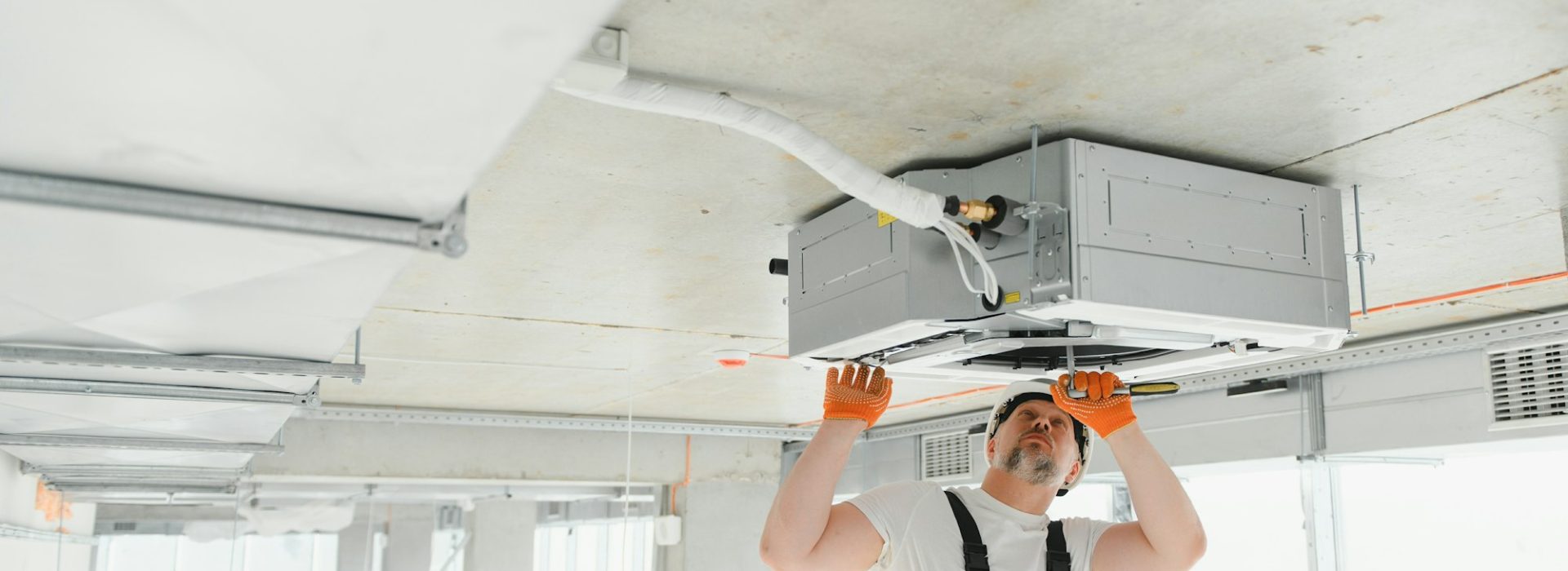 male-technician-installing-of-air-conditioner